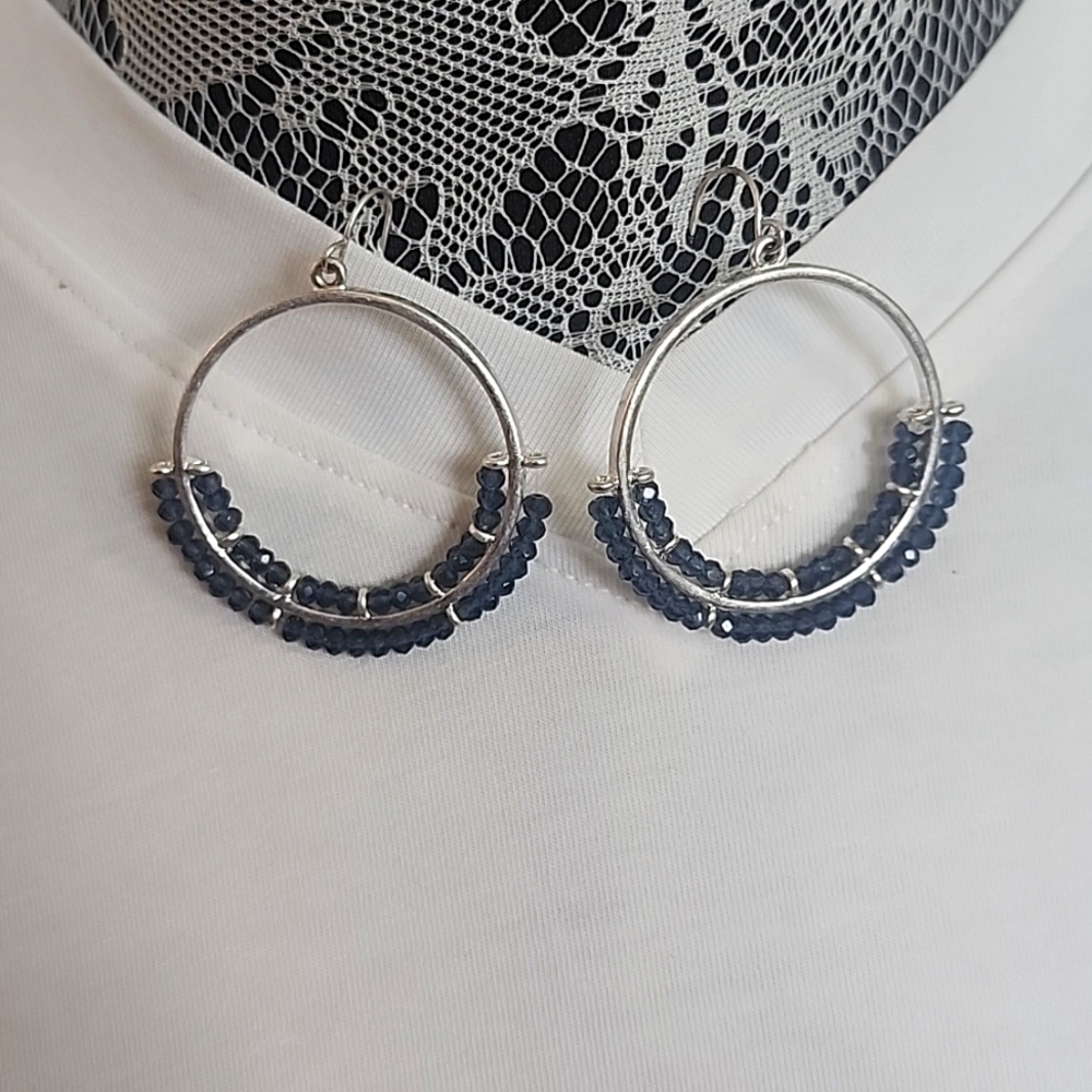 Silver hoop earrings with blue stones